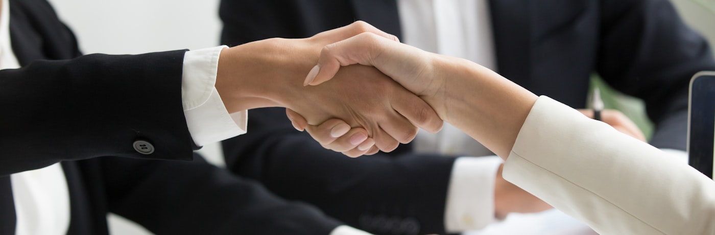 Business professionals shaking hands at an international gathering
